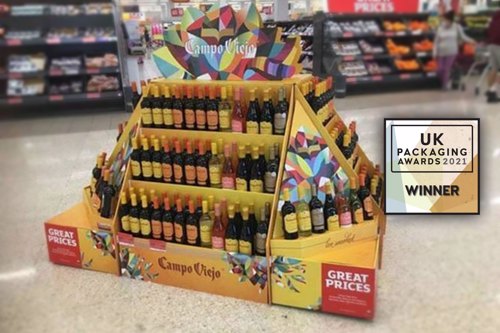 Image of display holding Campo wine bottles in store. Overlayed with small UK Packaging Awards 2021 Winner logo.