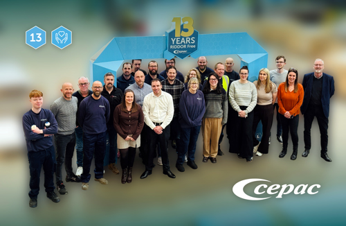 Photograph of a smiley Cepac team (20+ people) at our Doncater site. Behind the staff members is a corrugate display arch with message "13 years RIDDOR Free" and a Cepac logo.